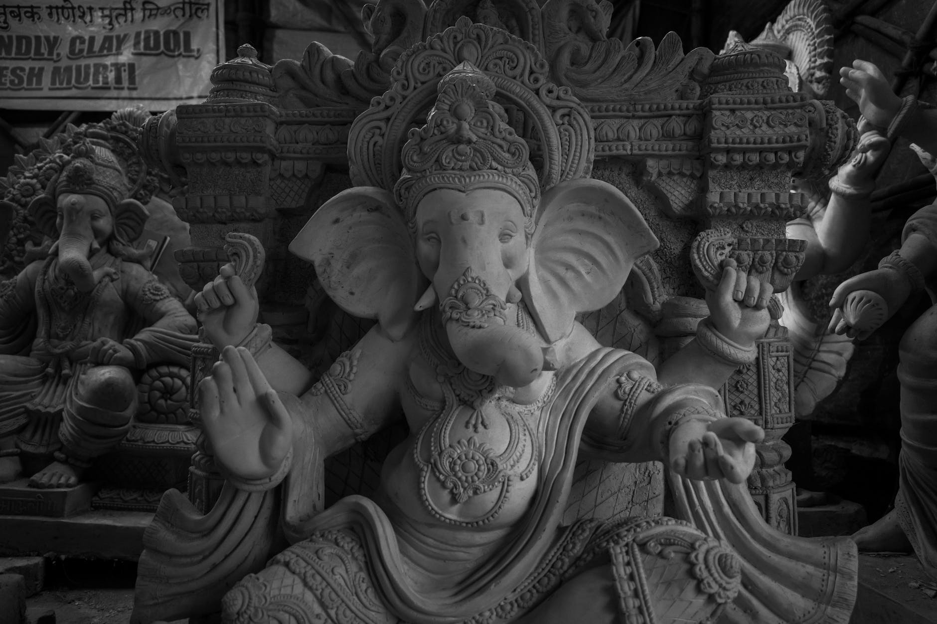 grayscale photo of ganesha statues