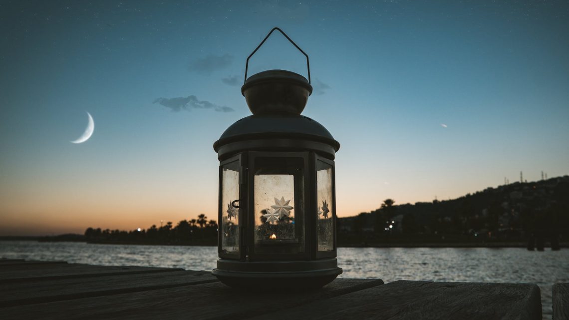 gray metal candle lantern on boat dock