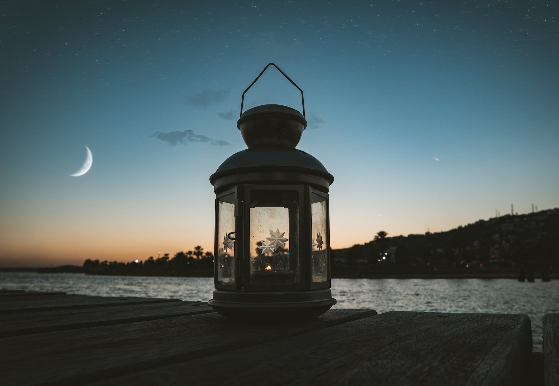 gray metal candle lantern on boat dock
